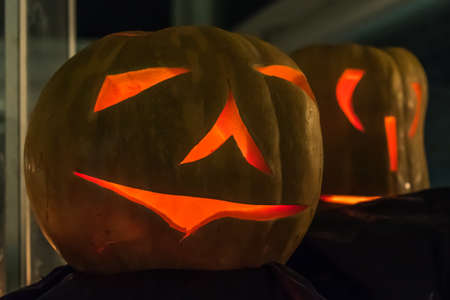 close-up of Halloween pumpkin at night. lighten from the inside at a Halloween party. fresh Pumpkin curvedの写真素材