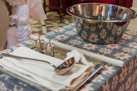 Church accessories for baptism ready on a table