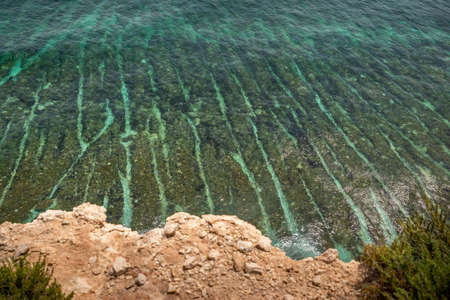 Landscape Around Marsascala Malta Cliffs, arch, crystal clear Mediterranean water around st thomas bay. side and above view. Serenity, tranquility. while tracking during winter with fresh  air.の写真素材