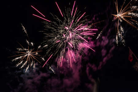 Gold, vilot and white color Fire Works During Feast during the feast of xewkija. st jhon the baptist. isolated on a black background sky at night. Malta Gozo. Xewkija during Summer in 2016の写真素材