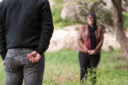Engagement Photos, rings visible on the hands in the nature. focused rings. blurred background.の写真素材