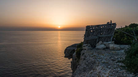 Sunset at the edge of a cliff in Malta Gozoの写真素材