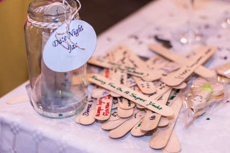 Date Night Jar Messages on wood. text at a hens party for the bride. Horizontal. Side View. Shallow depth of field. Ideasの写真素材