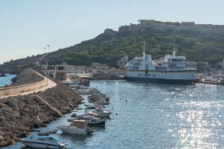 30th SEP 2018 Mgarr Gozo. Gozo Mgarr Harbor breakwater and another ship moored with chambre fort in view. on a sunny summer day.のeditorial素材