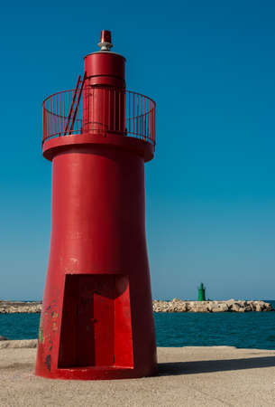 Red lighthouse on the coast of the Adriatic Sea in Croatiaの写真素材