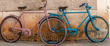 Bicycles parked in front of a stone wall in Rome, Italyの写真素材
