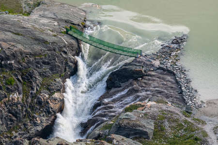 Hanging Bridge and Waterfall at Sandersee, Hohe Tauern National Park, Austriaの写真素材