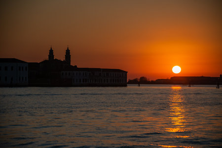 Orange sunset in December over the lagoon of Venice, silhouette of cityscapeの写真素材