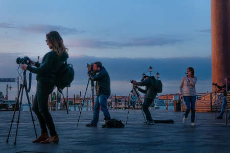 Photographers with tripoid and camera equipment waiting for sunrise at St.mark's square in Venice for the perfect shot, Venice, Italyのeditorial素材