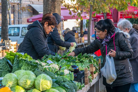 Customers shop for fresh fruit and vegetables on a sunny autumn day at Pula's City market ( Trznica ), Pula, Croatiaのeditorial素材