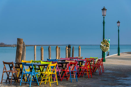 Colorful chairs and tables on the pier of Venice. Italy.の写真素材