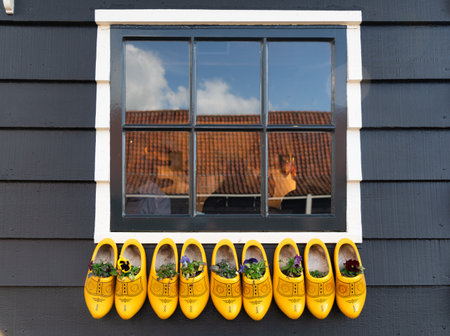 Wooden Dutch clogs in front of a window in the Netherlands