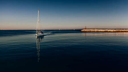 Boat returning to the port in the eveningの写真素材