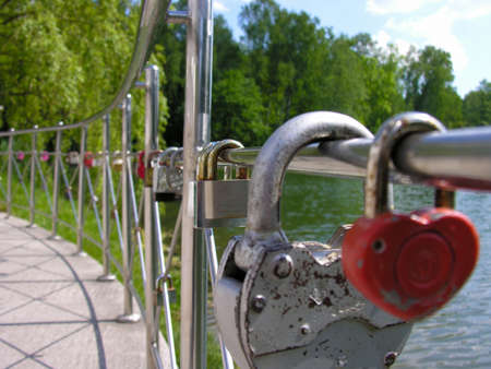 Wedding tradition - to seal the union lock on the fence embankmentの写真素材