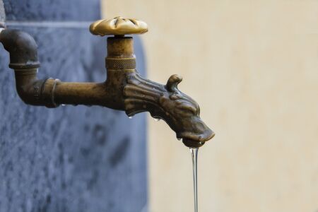 Old Italian outdoor water tapの写真素材