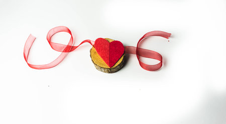 Valentine, handmade heart on wood with ribbons. isolated white backgroundの写真素材