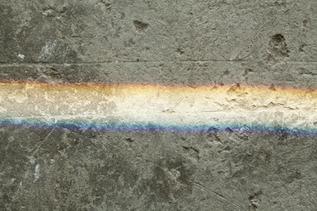 Rainbow lighting on dirty concrete groundの写真素材