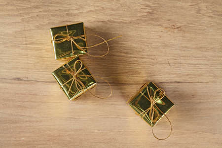 Triple golden box on woodenの写真素材