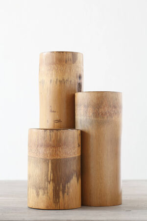 Triple dry bamboo segment oon wooden table Triple dry bamboo segment oon wooden table
