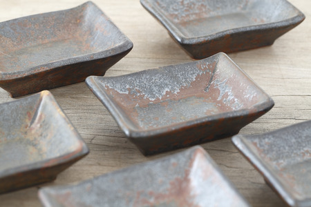 Antique ceramic sauce on wooden table 