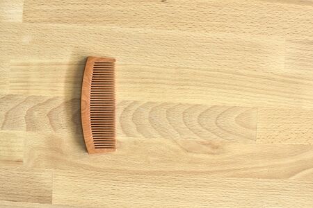 Wood comb on wood plate (Top View)の写真素材