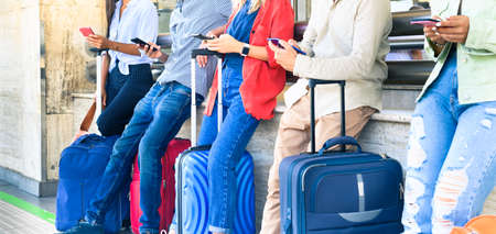Multiracial friends using mobile smart phones apps - Young people addiction to new technology trends - Concept of youth, tech, social and friendship - Focus on center handsの写真素材