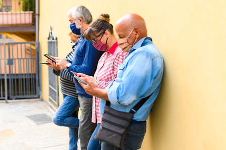 Group of senior friends watching smart mobile phones - Retired friends addiction to new technology...
