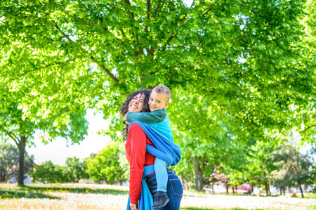 Smiling young mother with her beautiful son take a selfie photo in the garden - Funny, joy, cute, lovely concept about little happy boy eat an apple the girl drink coffeeの写真素材