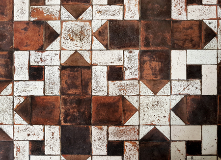 Old floor. Different shape and color scuffed tiles background