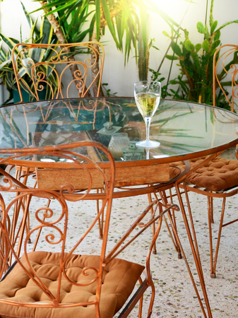 glass on white wine on retro style rusty metal tableの写真素材