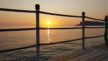 Enjoying sunset on the pier. Concept for vacation in Alanya, Turkeyの写真素材
