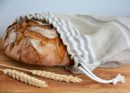 Bread loaf in reusable zero waste linen bread bag, close-up viewの写真素材