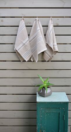 Striped rough heavy linen kitchen or hand towels on wooden background. Home textileの写真素材