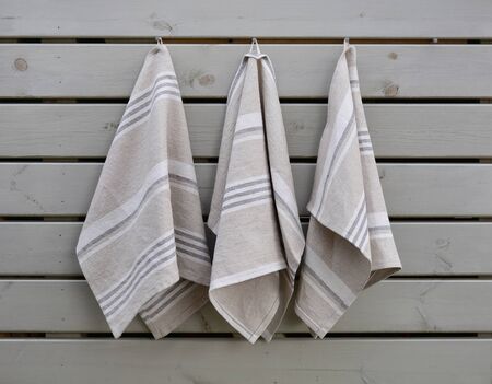Striped rough heavy linen kitchen or hand towels on wooden background. Home textileの写真素材