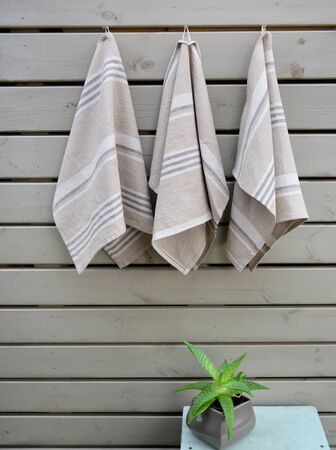 Striped rough heavy linen kitchen or hand towels on wooden background. Home textileの写真素材