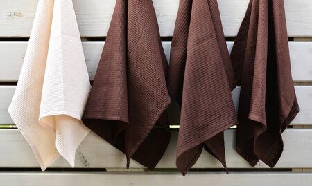 Waffle weave kitchen or hand towels on wooden planks background. Home textileの写真素材