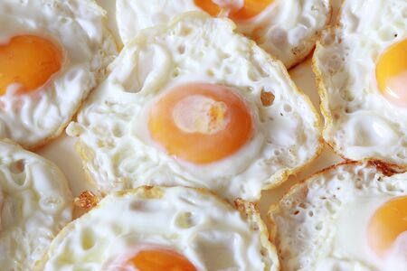 background of fried eggs on a plateの写真素材