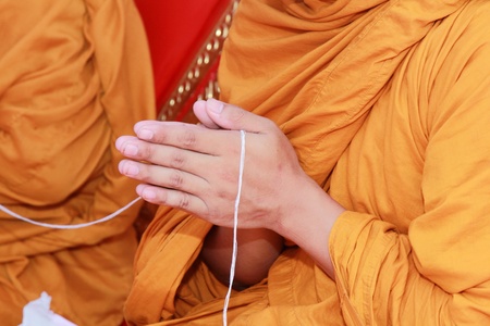 hands of buddhist monk praying for the buddhist in a ceremony