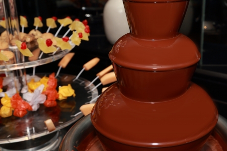 chocolate fountain with fruit and marshmallow backgroundの写真素材