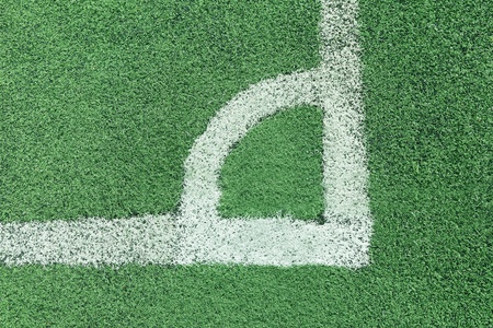 corner of a synthetic football field with white stripe