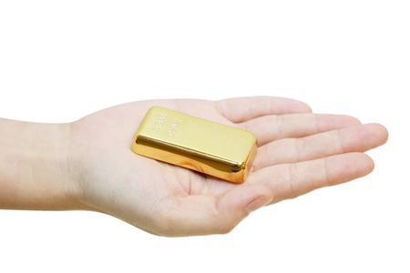 isolated gold bar in a hand in white backgroundの写真素材