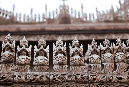detail of carved wooden statue at Shwenandaw Kyaung Templeの写真素材