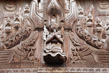 detail of carved wooden statue at Shwenandaw Kyaung Templeの写真素材