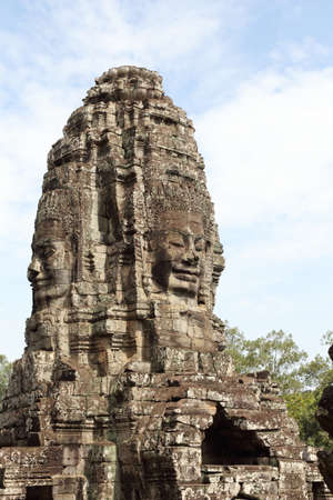 ancient stone face of bayon temple in angkor thom cambodiaの写真素材