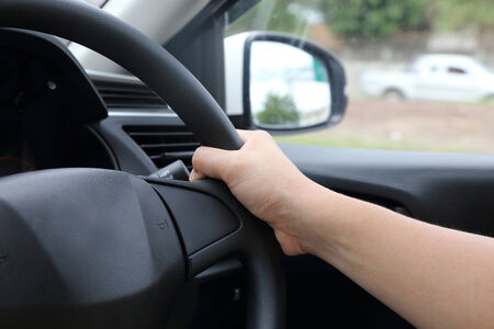 male hand on steering wheel