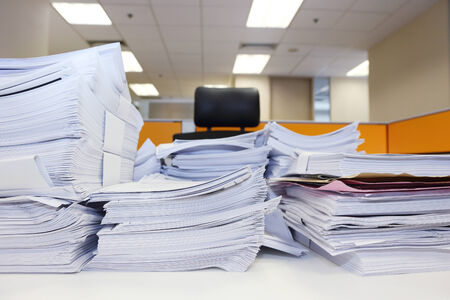 pile of documents on the office table