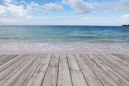 wood terrace on the beach with blue skyの写真素材