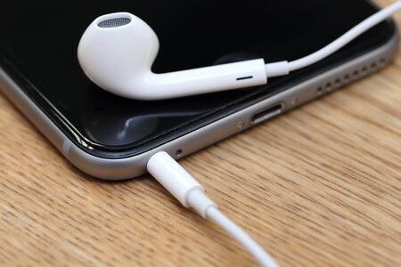 BANGKOK THAILAND FEBRUARY 16 2015: close up image of apple earpods onthe wooden table on February 16...