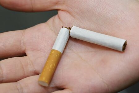 broken cigarette on the palm after quite smokeの写真素材