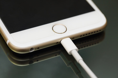 BANGKOK, THAILAND -APRIL 17, 2015: close up image of the new apple iphone6 with the charging cable ...